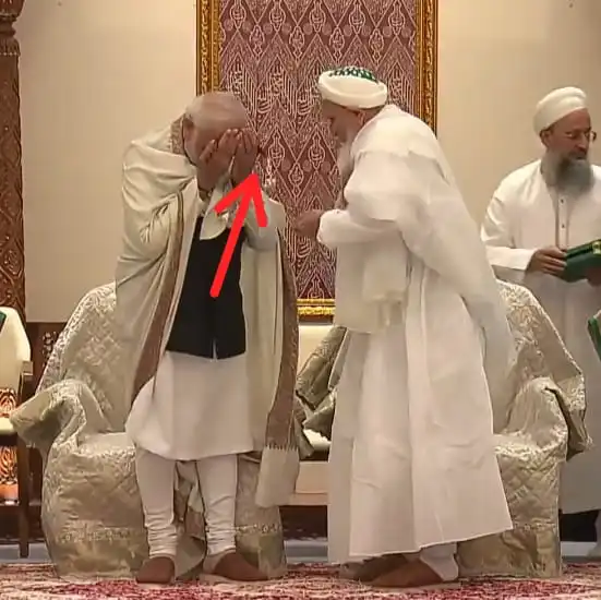 PM Modi touching mala with his forehead which looks like he is offering namaz
